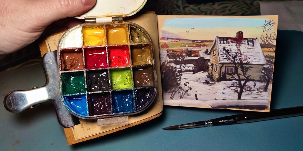 färger i en palett och ett målat hus