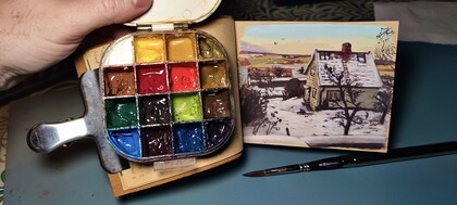 färger i en palett och målad bild av ett hus