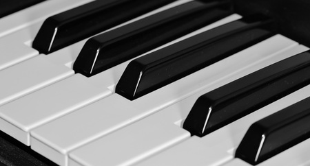 Närbild av svarta och vita tangenter på ett piano eller keyboard.