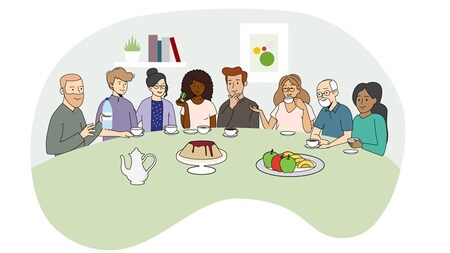 Åtta personer sitter vid ett bord och fikar.