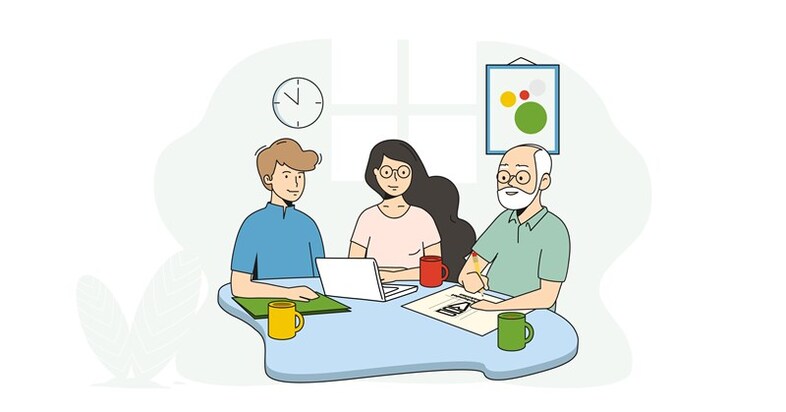 Tre personer sitter vid ett bord och arbetar.