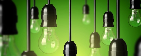 Flera hängande glödlampor mot grön bakgrund, en lampa lyser medan resten är släckta.