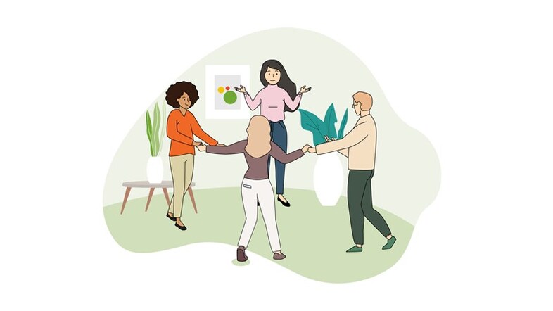 Fyra personer står i en ring och håller varandra händer.