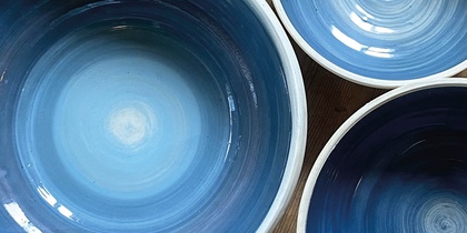 Tre blå keramikskålar på ett trägolv med texten 'Prova på: Keramik' i hörnet.