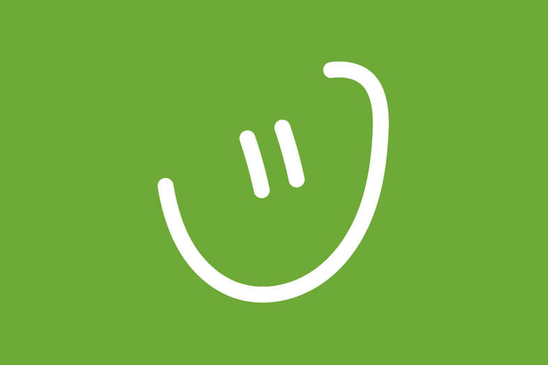 En enkel, vit, tecknad smiley på grön bakgrund.