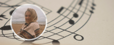 Kvinna med blont hår på en strand, inramad mot en bakgrund av noter på papper.