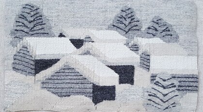 Vävd bild av snötäckta hus och träd i ett vinterlandskap, i grå och vita nyanser.