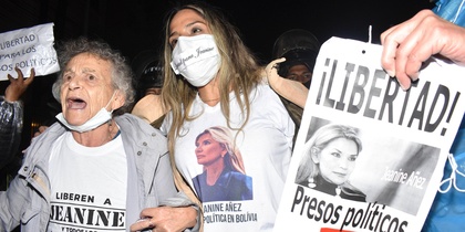 Två kvinnor demonstrerar för frigivning av Jeanine Áñez med skyltar och t-shirts med hennes bild.