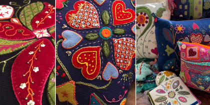 Färgglada kuddar och textilier med broderade hjärtan, blommor och blad i folkart-stil.