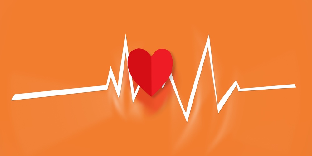 Röd hjärtsymbol med vit EKG-linje på orange bakgrund.