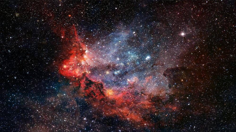 Färgstark nebulosa i rymden med stjärnor och gasmoln i rött, blått och svart.